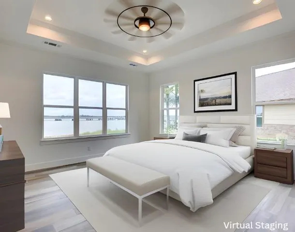 a bedroom with a large bed and a large window