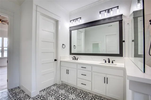a bathroom with double vanity sink and a mirror