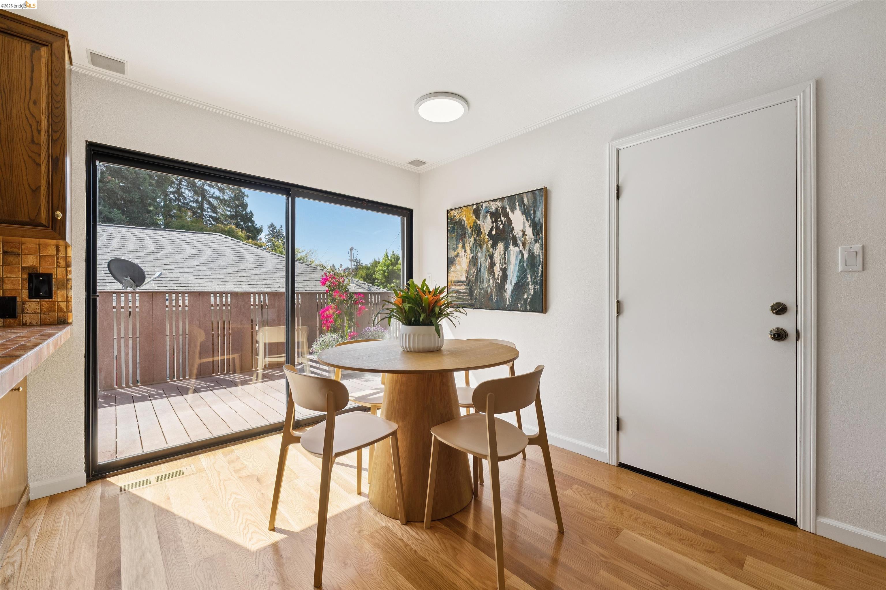 7 Jo Lin Court El Sobrante, CA 94803 - Photo 51 of 99 Dining area featuring wood-finish flooring, a contemporary ceiling light fixture, and a white interior door
