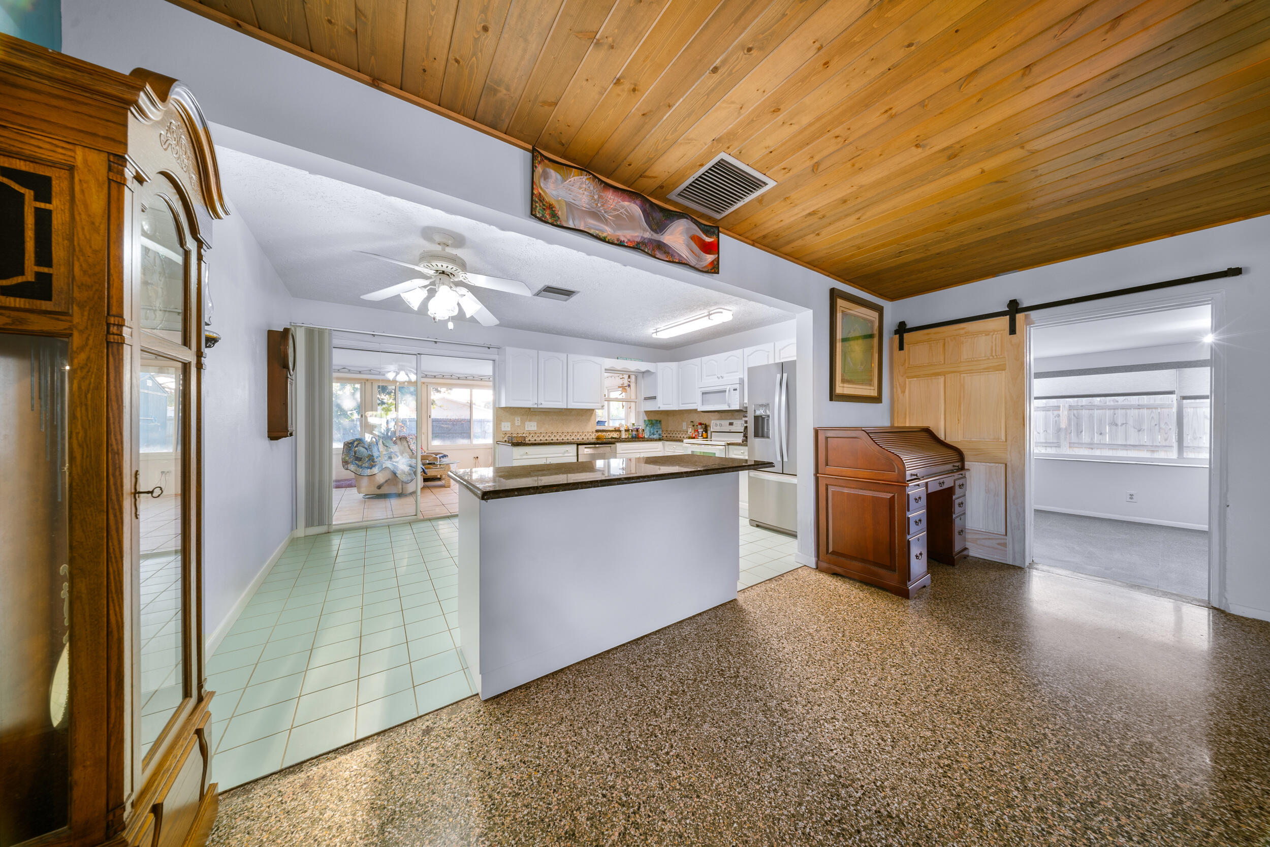 311 Granada Street Fort Pierce, FL 34949 - Photo 11 of 58 a kitchen with refrigerator and cabinets