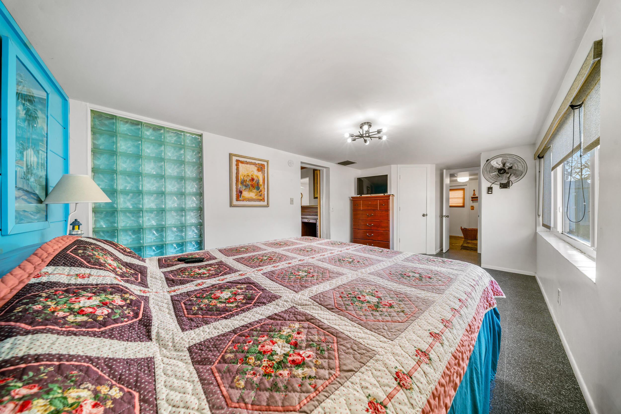 311 Granada Street Fort Pierce, FL 34949 - Photo 17 of 58 a bedroom with a bed and a lamp on dresser