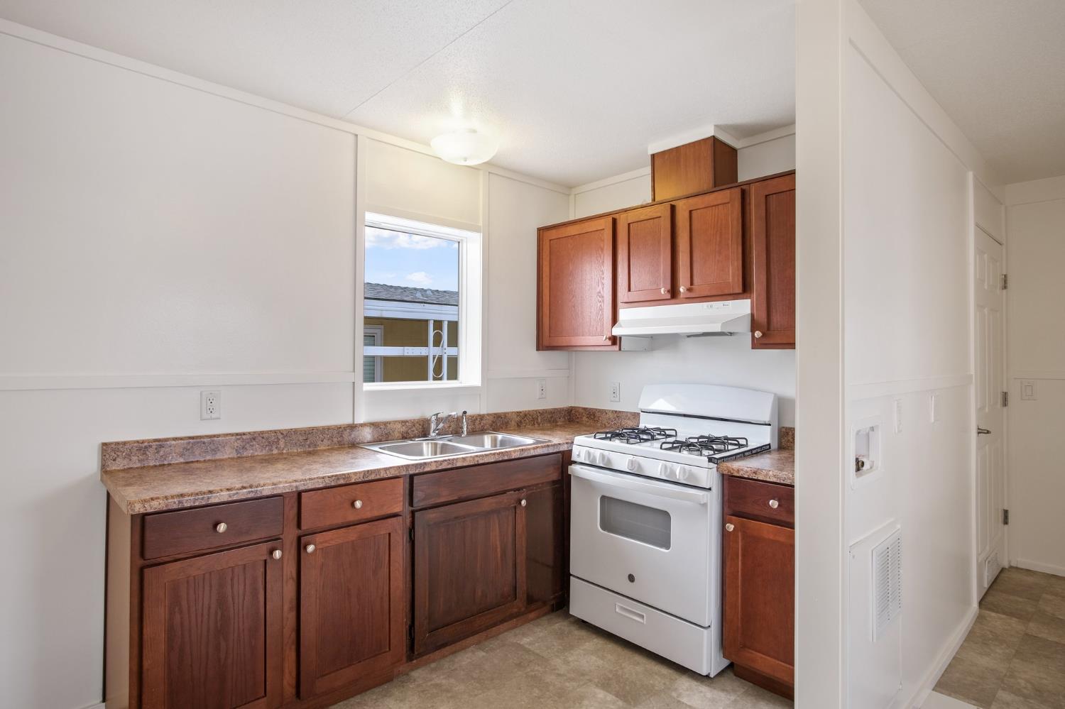 1400 Meredith Avenue, Unit 81 Gustine, CA 95322 - Photo 19 of 29 a kitchen with a sink stove and cabinets