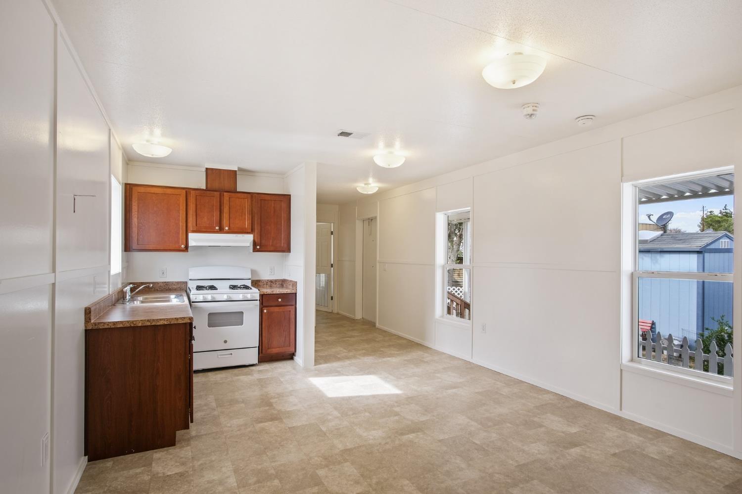1400 Meredith Avenue, Unit 81 Gustine, CA 95322 - Photo 24 of 29 a kitchen with stainless steel appliances granite countertop a refrigerator and a stove top oven