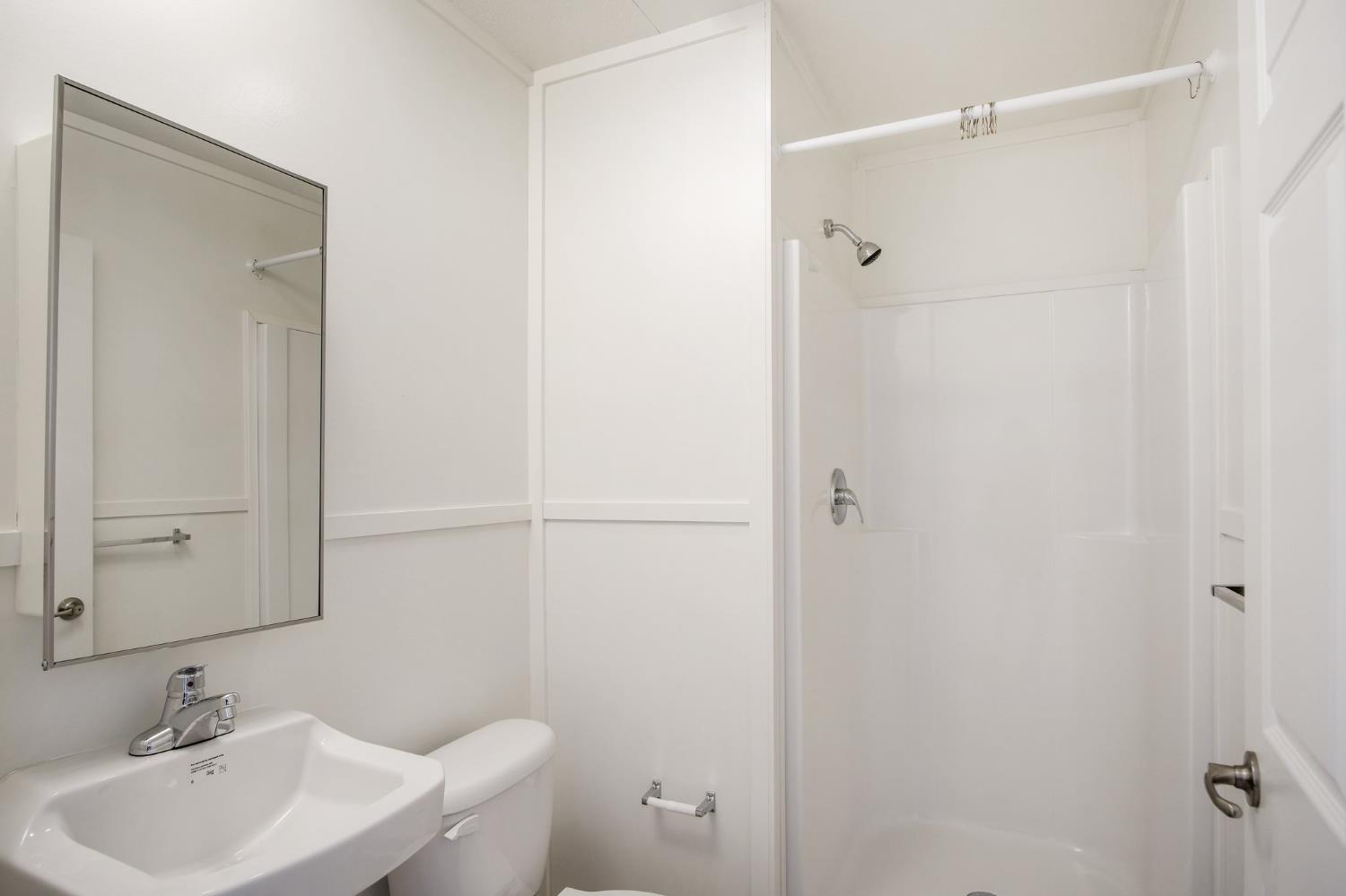 1400 Meredith Avenue, Unit 81 Gustine, CA 95322 - Photo 28 of 29 a bathroom with a sink a toilet and shower