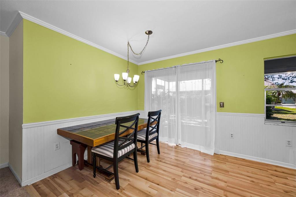 9427 Cape Charles Avenue New Port Richey, FL 34655 - Photo 11 of 82 a view of a dining room with furniture window and wooden floor