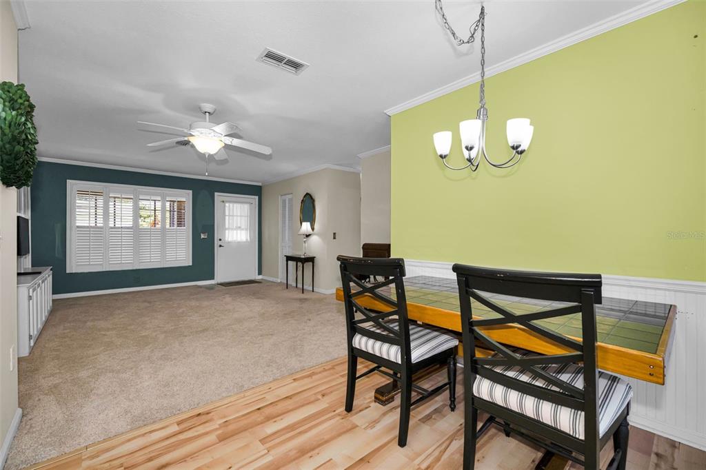 9427 Cape Charles Avenue New Port Richey, FL 34655 - Photo 13 of 82 a view of a dining room with furniture and chandelier