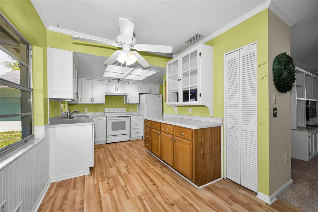 9427 Cape Charles Avenue New Port Richey, FL 34655 - Photo 15 of 82 a kitchen with stainless steel appliances granite countertop a sink and dishwasher a stove top oven with wooden floor