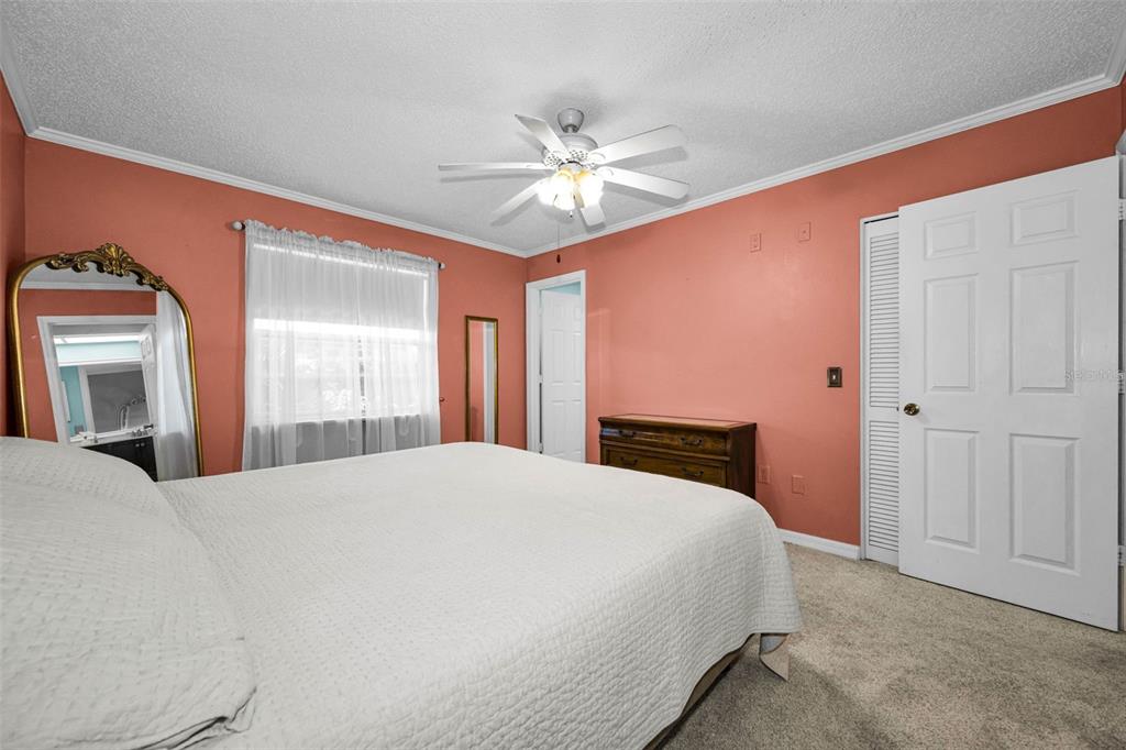 9427 Cape Charles Avenue New Port Richey, FL 34655 - Photo 22 of 82 a bedroom with a bed and a chandelier