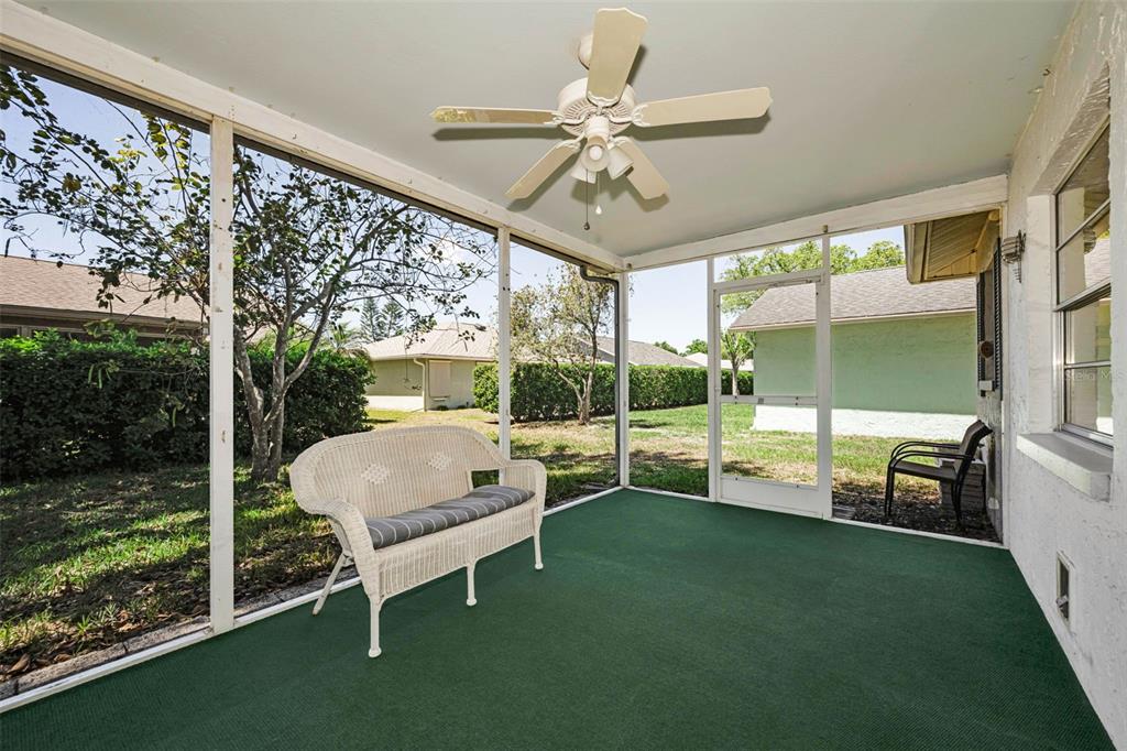 9427 Cape Charles Avenue New Port Richey, FL 34655 - Photo 28 of 82 a view of porch with a table chairs and a yard