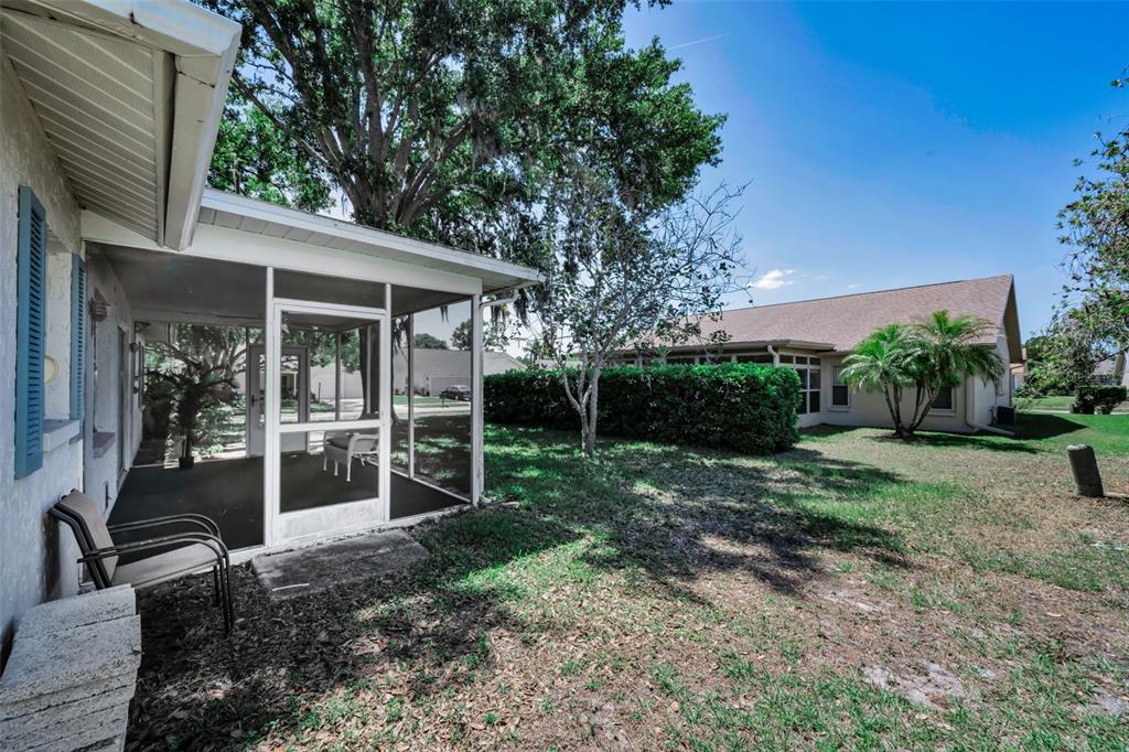 9427 Cape Charles Avenue New Port Richey, FL 34655 - Photo 30 of 82 a view of a house with backyard porch and garden