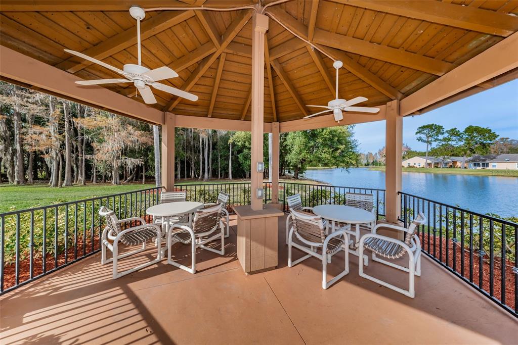 9427 Cape Charles Avenue New Port Richey, FL 34655 - Photo 50 of 82 a view of a patio with a table chairs and a backyard