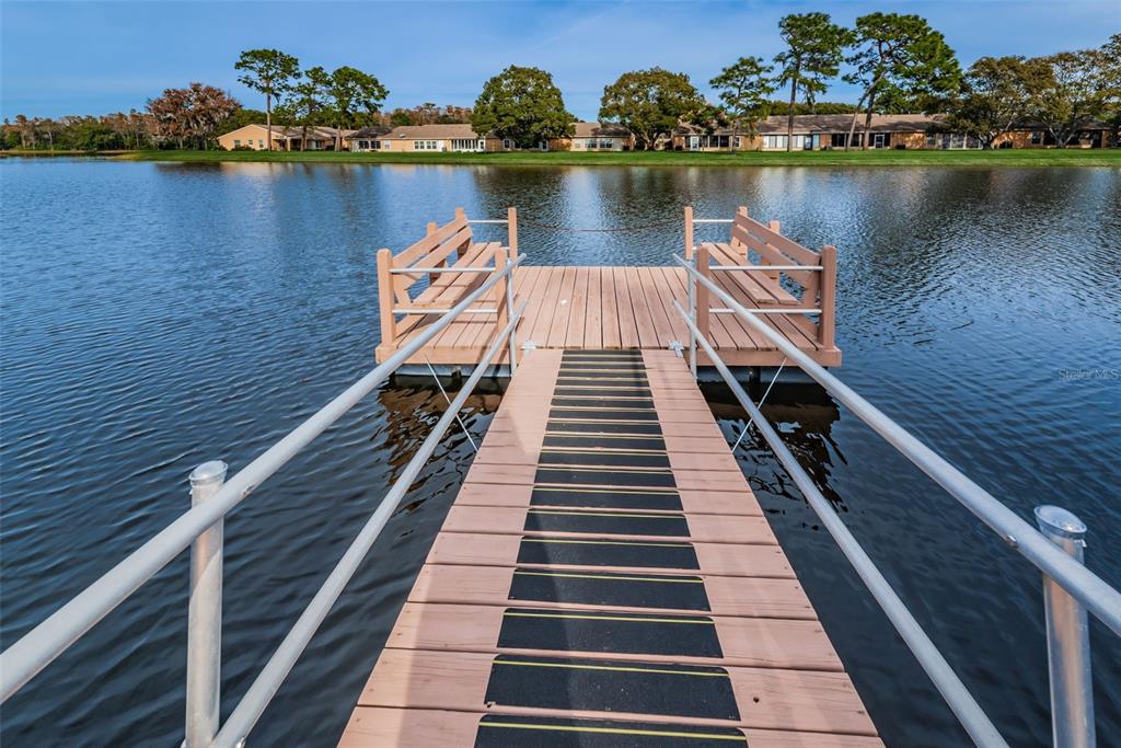 9427 Cape Charles Avenue New Port Richey, FL 34655 - Photo 53 of 82 an aerial view of a balcony with wooden floor and lake view