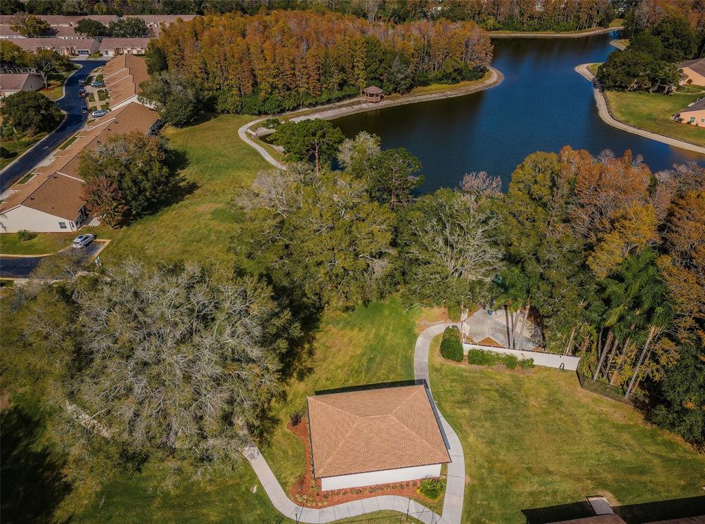 9427 Cape Charles Avenue New Port Richey, FL 34655 - Photo 75 of 82 an aerial view of a house with a yard and lake view