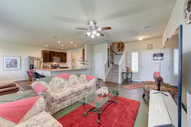 a living room with furniture and kitchen view