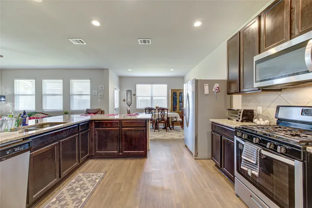 a kitchen with lots of counter top space and stainless steel appliances