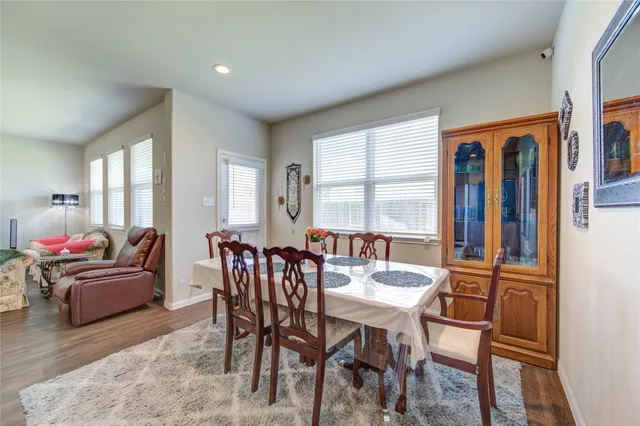 a dining room with furniture and window