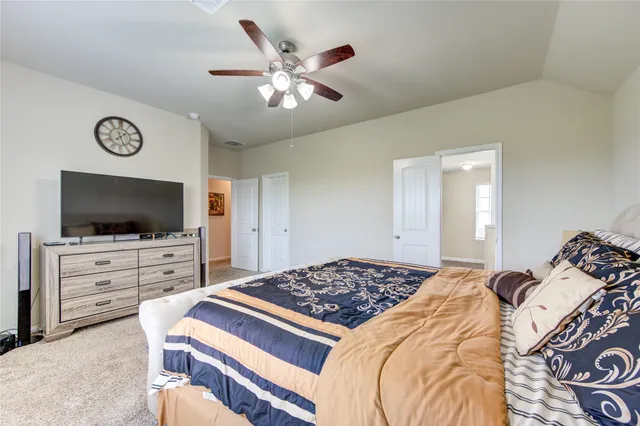 a bedroom with a bed and flat screen tv