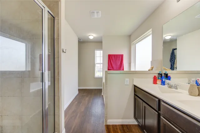 a kitchen with a sink cabinets and wooden floor