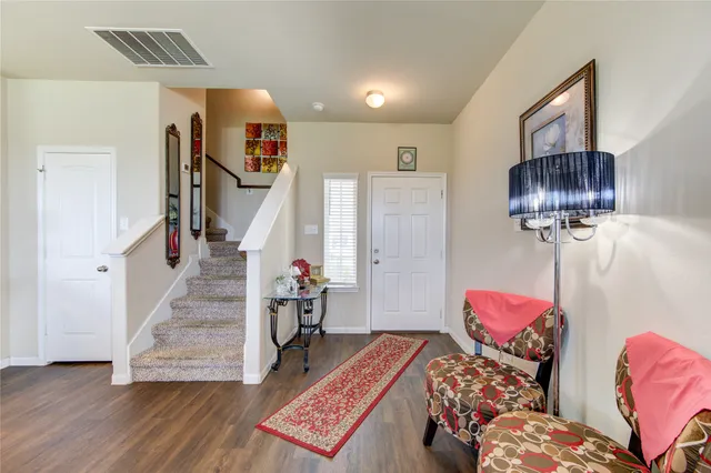 a bedroom with furniture and a wooden floor