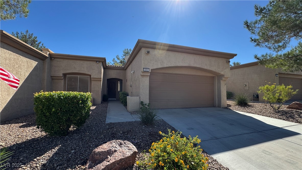 Mediterranean / spanish home with driveway, stucco siding, and an attached garage
