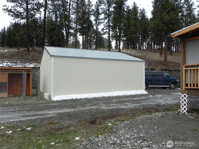 a view of dirt yard with a large tree