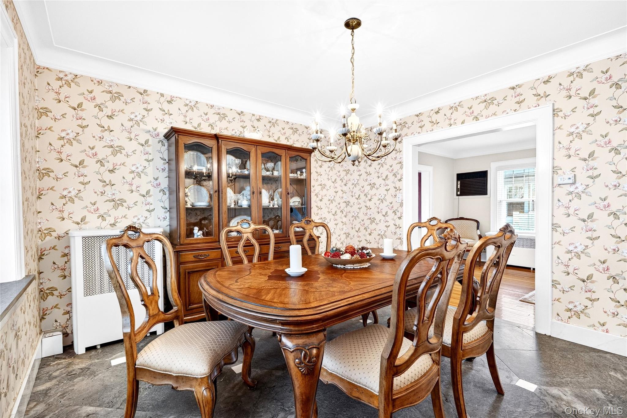 3334 Country Club Road Bronx, NY 10465 - Photo 13 of 49 Dining room with a chandelier, radiator heating unit, wallpapered walls, and ornamental molding