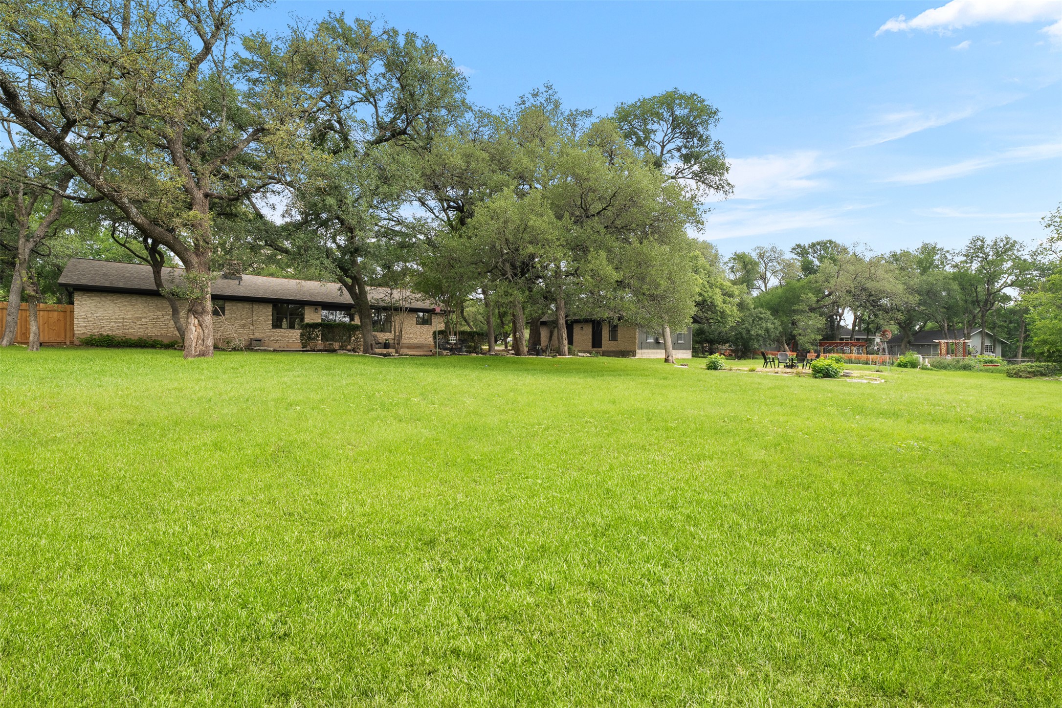 303 West Sequoia Spur Georgetown, TX 78628 - Photo 25 of 34 a view of a house with a big yard and large trees