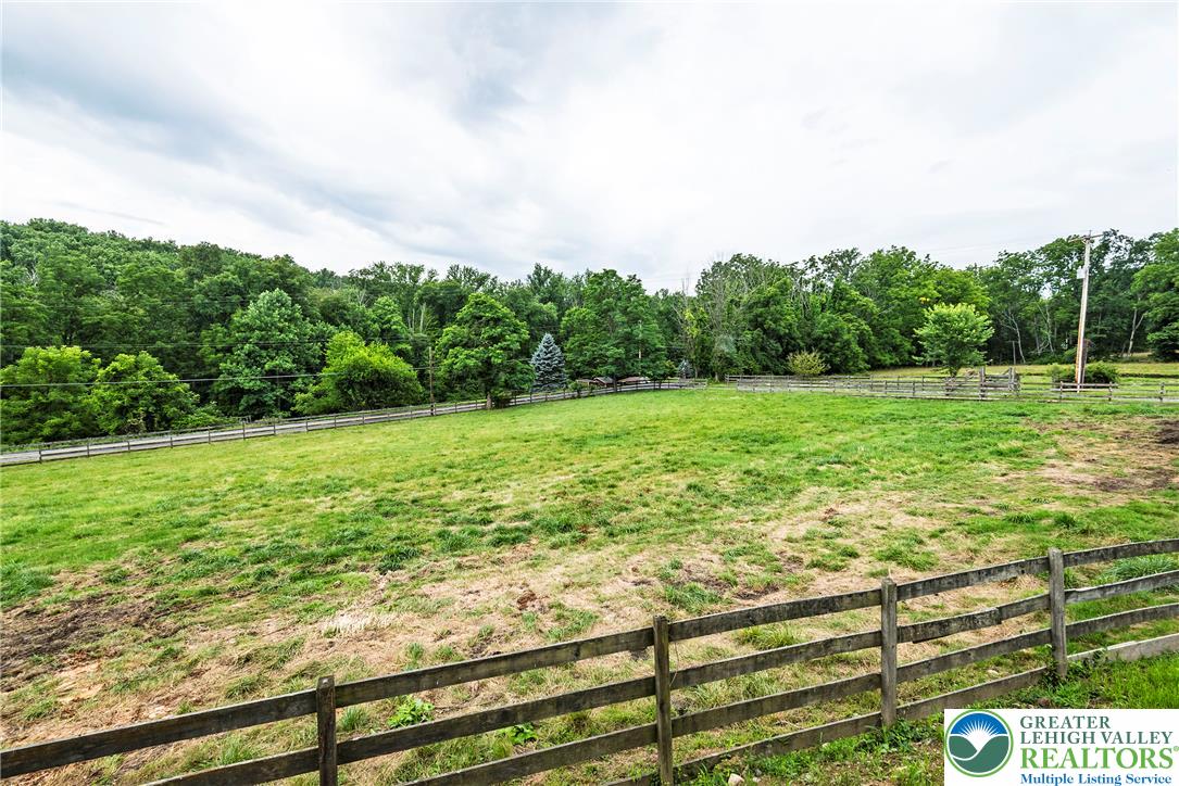 72 Allegheny Road Mount Bethel, PA 18343 - Photo 65 of 72 A verdant, open pasture, framed by a classic wooden fence, offers vast potential for equestrian pursuits.