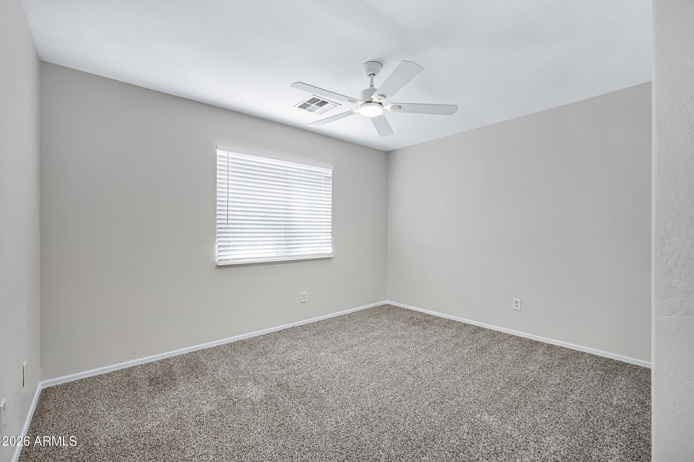19408 North Braden Road Maricopa, AZ 85138 - Photo 42 of 51 an empty room with a window and a fan