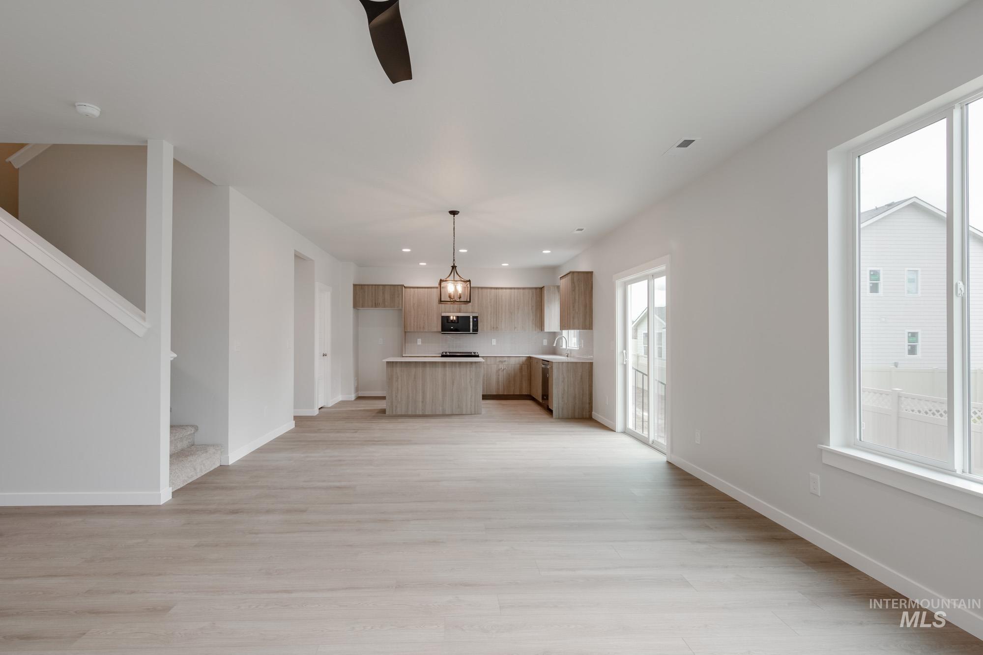 10575 West Teratai Street Star, ID 83669 - Photo 13 of 26 Unfurnished living room with recessed lighting, light wood-style flooring, and stairs