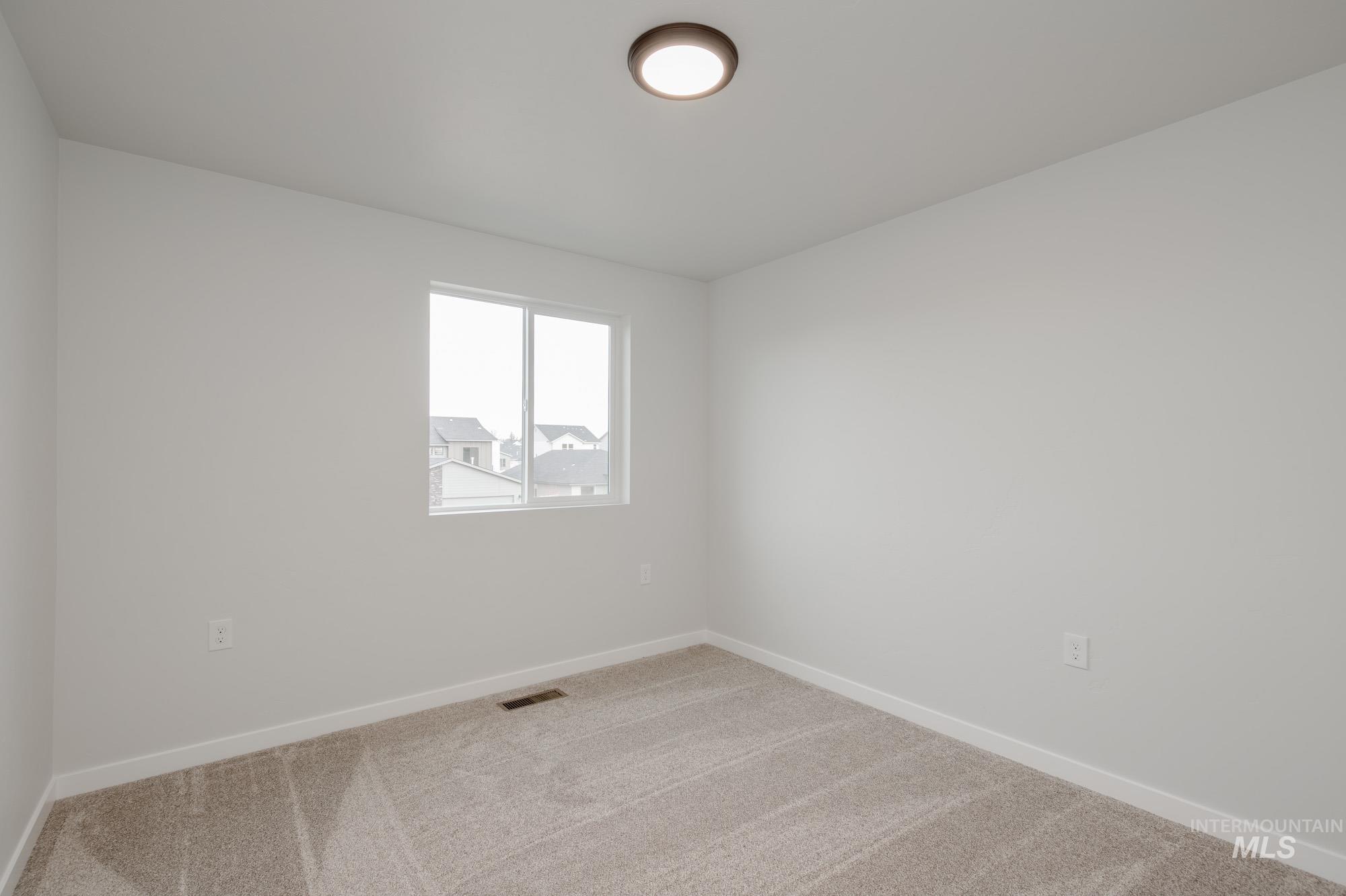 10575 West Teratai Street Star, ID 83669 - Photo 17 of 26 Spare room featuring baseboards and carpet