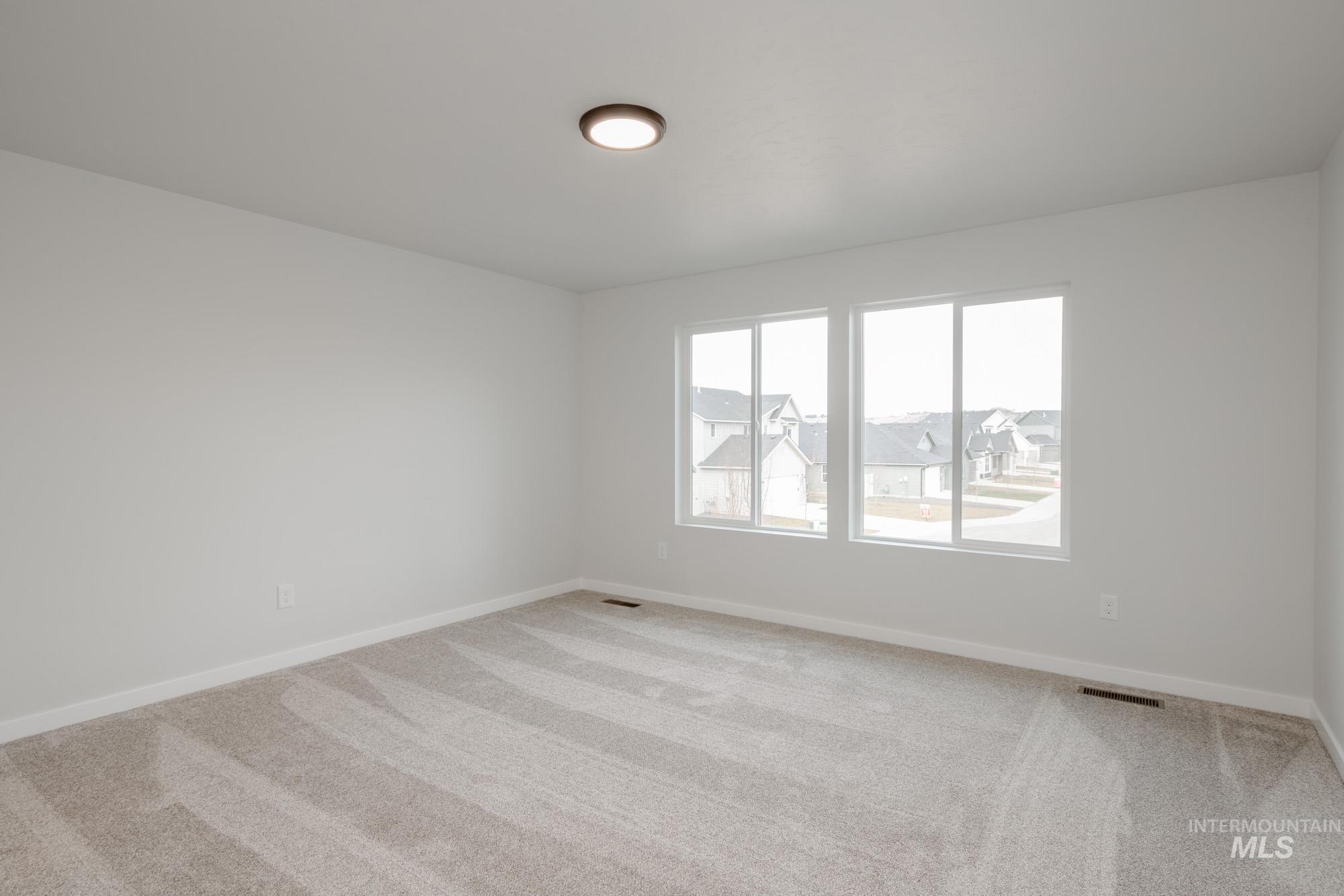 10575 West Teratai Street Star, ID 83669 - Photo 22 of 26 Empty room featuring light colored carpet and baseboards