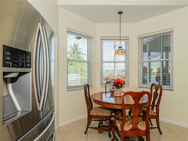 a dining room with furniture a chandelier and window