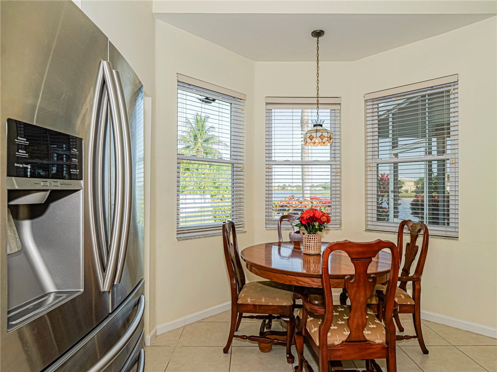 6258 Arlington Way Fort Pierce, FL 34951 - Photo 13 of 36 a dining room with furniture a chandelier and window