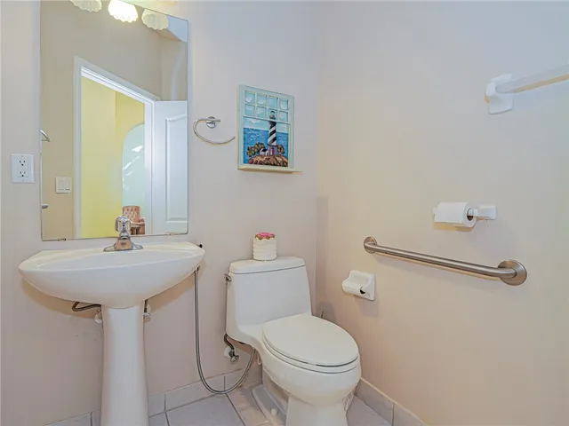 a bathroom with a sink mirror and toilet