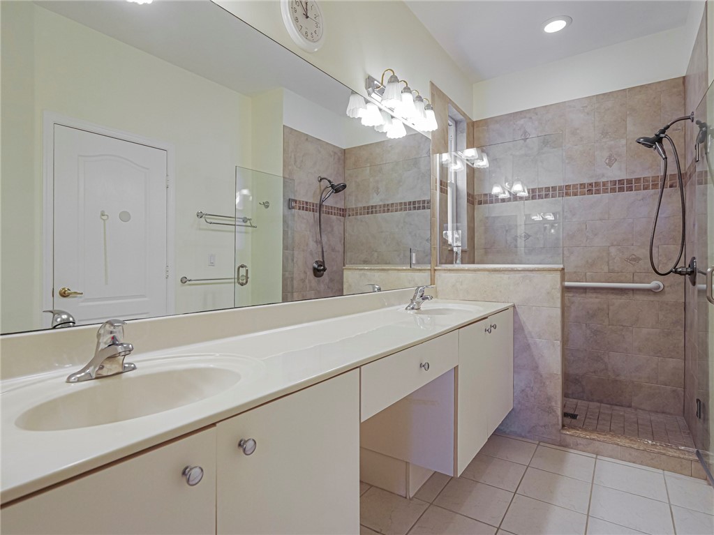 6258 Arlington Way Fort Pierce, FL 34951 - Photo 18 of 36 a bathroom with a double vanity sink mirror and shower