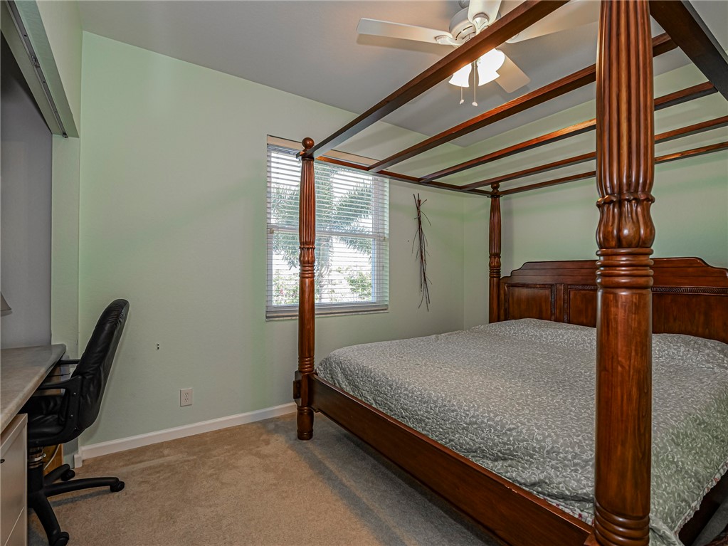 6258 Arlington Way Fort Pierce, FL 34951 - Photo 21 of 36 a bedroom with a bed window and chair