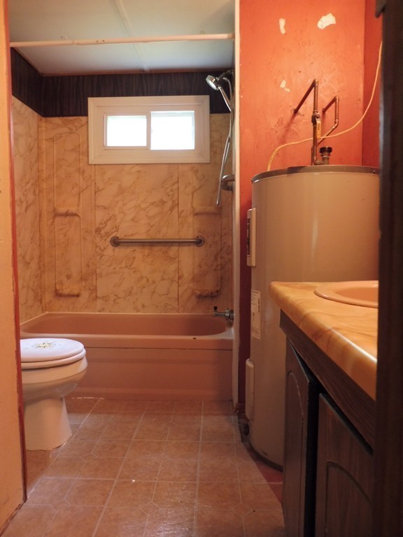 145 Holt Road Ashburnham, MA 01430 - Photo 7 of 13 a bathroom with a granite countertop toilet and a bathtub