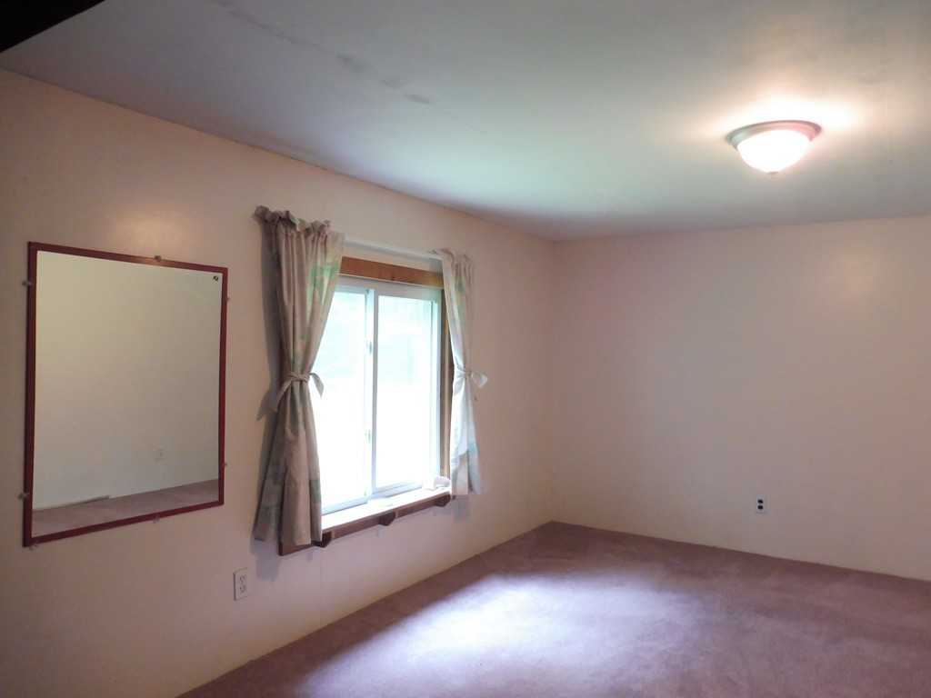 145 Holt Road Ashburnham, MA 01430 - Photo 9 of 13 an empty room with a window