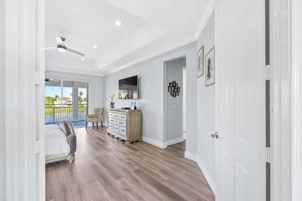 a large living room with a large window and chandelier