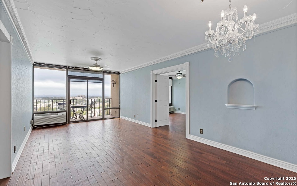 7701 Wurzbach Road, Unit 1205 San Antonio, TX 78229 - Photo 17 of 38 a view of an empty room with a window and wooden floor