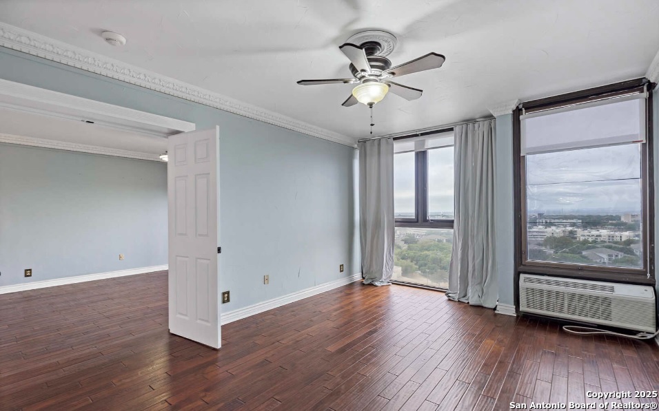 7701 Wurzbach Road, Unit 1205 San Antonio, TX 78229 - Photo 19 of 38 a view of an empty room with wooden floor and a window
