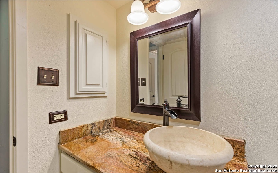 7701 Wurzbach Road, Unit 1205 San Antonio, TX 78229 - Photo 28 of 38 a bathroom with a sink and a mirror