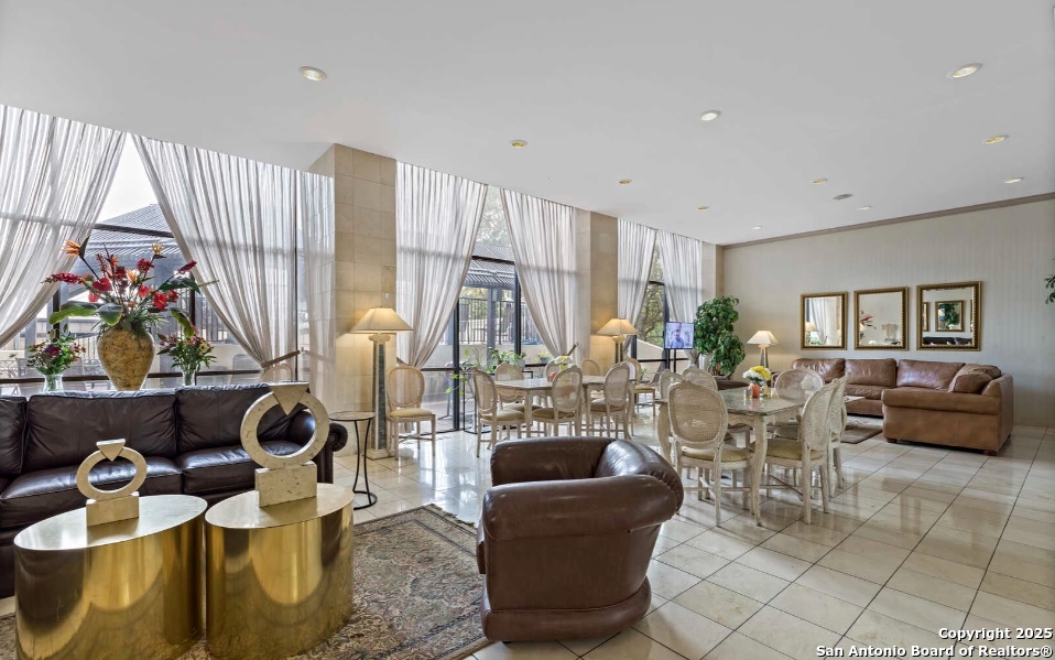 7701 Wurzbach Road, Unit 1205 San Antonio, TX 78229 - Photo 33 of 38 a living room with furniture and a floor to ceiling window