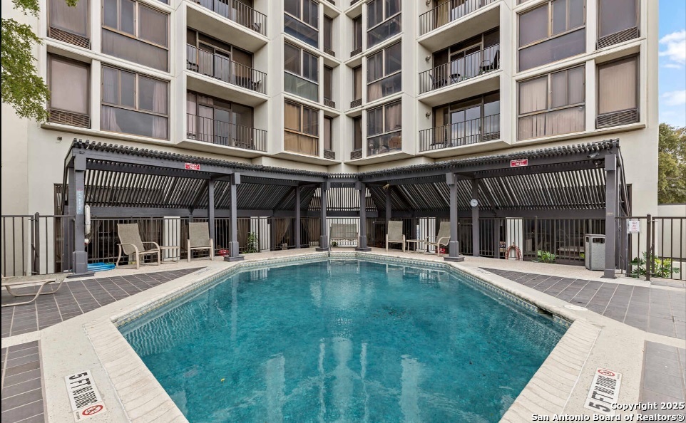 7701 Wurzbach Road, Unit 1205 San Antonio, TX 78229 - Photo 35 of 38 front view of an buildings with a swimming pool