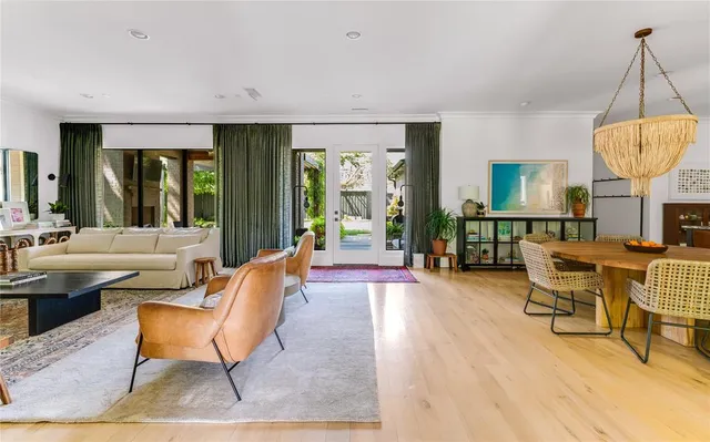 a living room with furniture a table and large windows