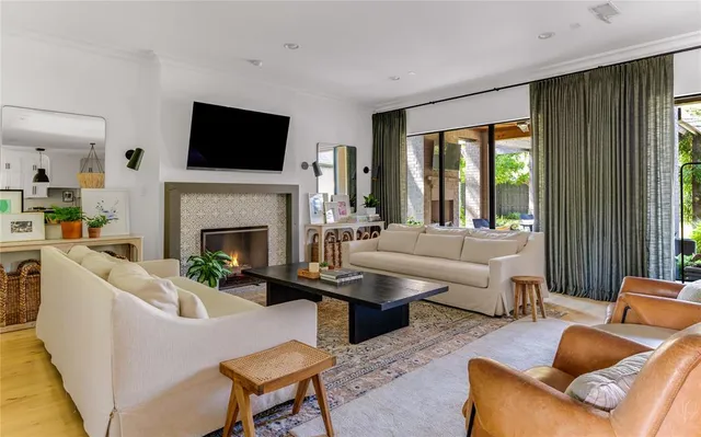 a living room with furniture fireplace and window