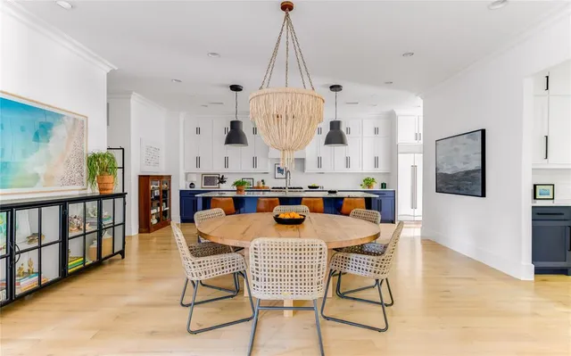 a dining room with furniture a chandelier and wooden floor