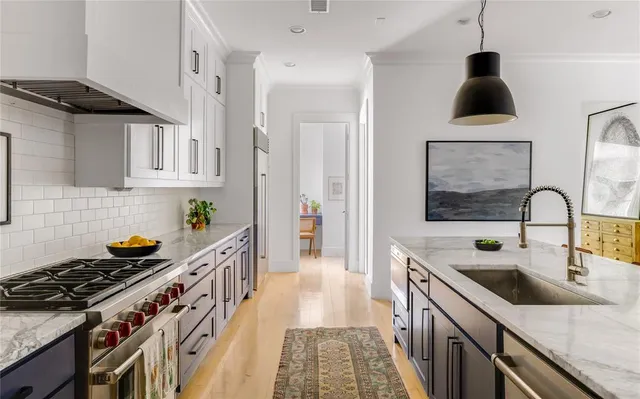a kitchen with stainless steel appliances granite countertop a stove and a sink