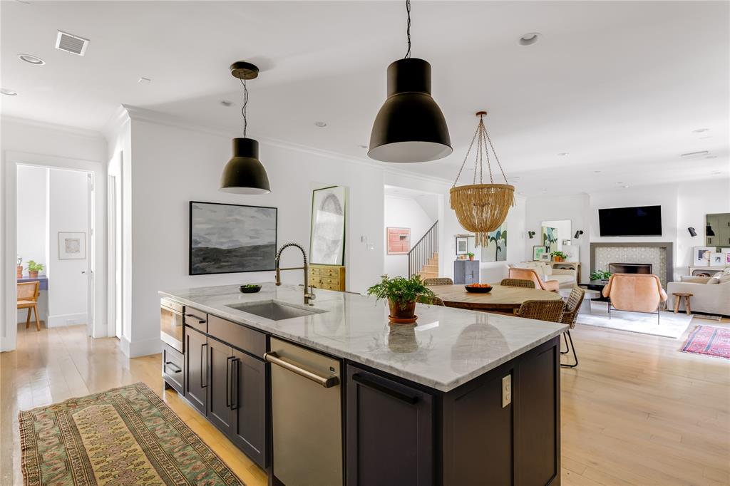 6905 Northridge Drive Dallas, TX 75214 - Photo 17 of 35 a kitchen with stainless steel appliances granite countertop a sink a stove and a wooden floors